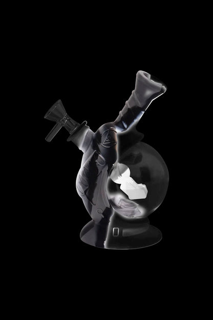 Glass water pipe (bong) with intricate sculpting, isolated on a black background.