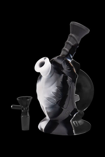 Black and white glass water pipe with a removable downstem, isolated on a black background.
