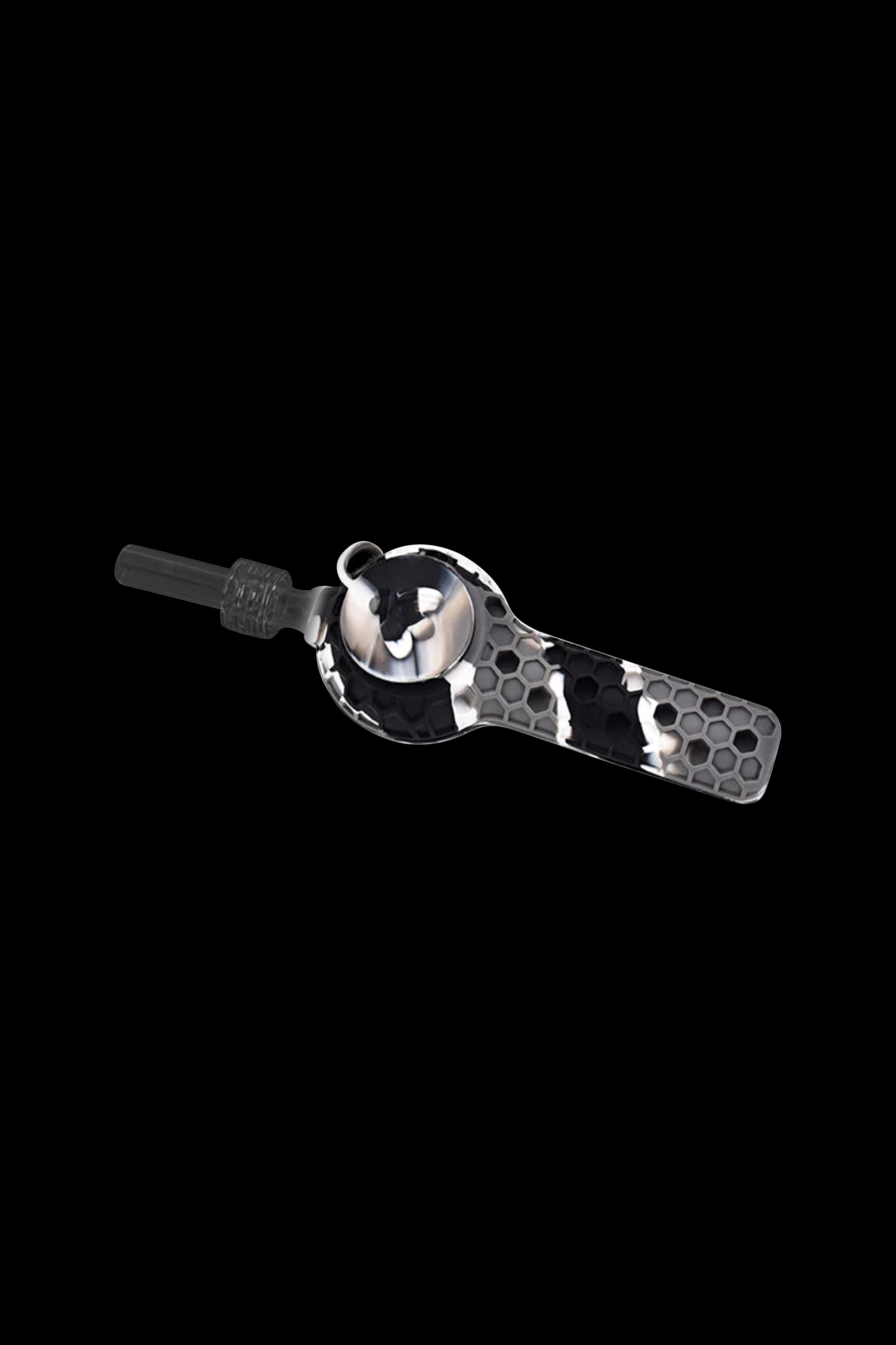Black and white honeycomb patterned silicone dab straw with a glass tip, isolated on a black background.