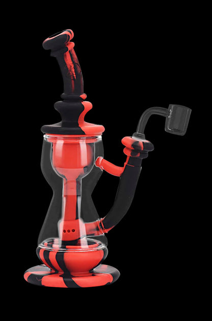 Red and black glass dab rig with a quartz banger.