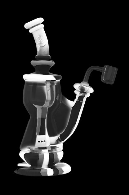 Clear glass dab rig with intricate curves and a quartz banger.