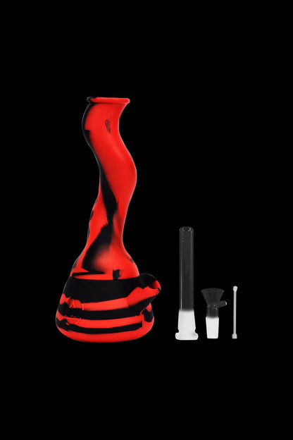 Red glass water pipe (rig) with accompanying glass downstem and quartz insert, isolated on a black background.