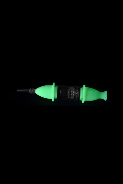 Glowing green dab syringe with glass tip and intricate internal structure.
