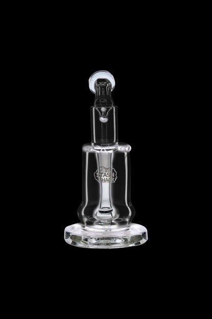 Clear glass dab rig with etched logo, isolated on black.