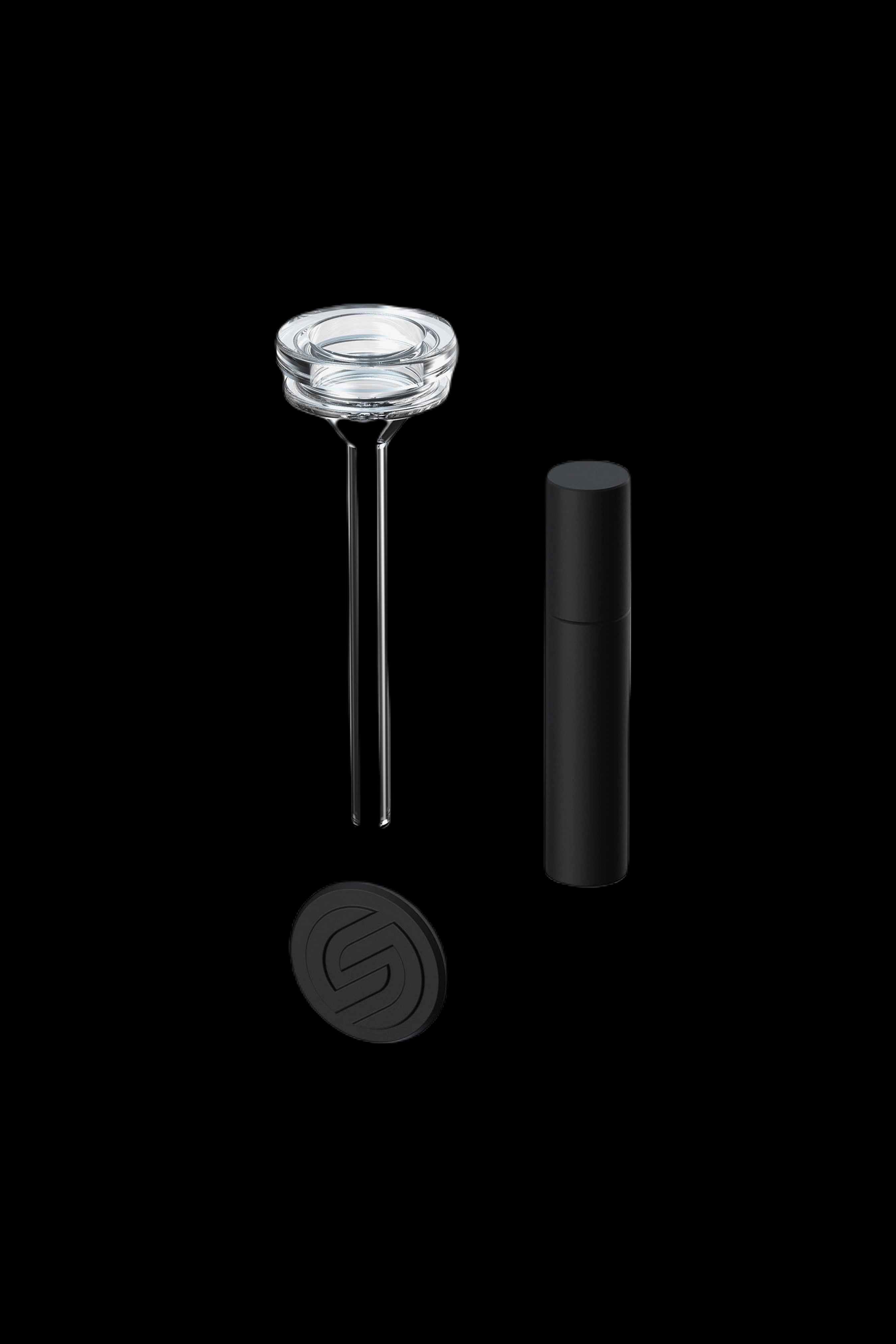 Disassembled cannabis oil burner with glass tip, metal rods, and black base.