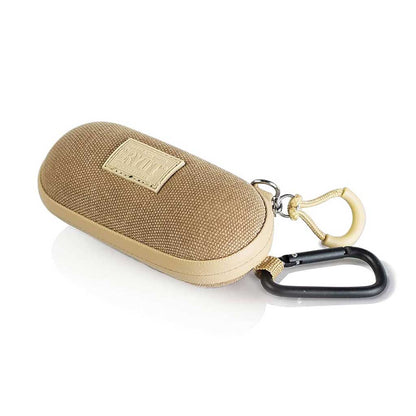 Angled front view of a tan RYOT Hardcase with woven fabric top, leather trim, branded patch, and attached black carabiner on a white background