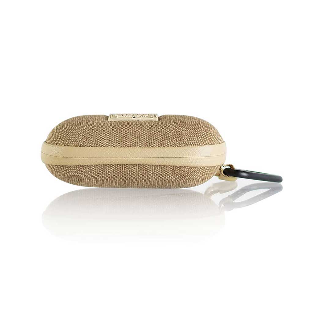 Side profile of a tan woven RYOT Hardcase with a cream zipper band and black carabiner reflected on a white surface.