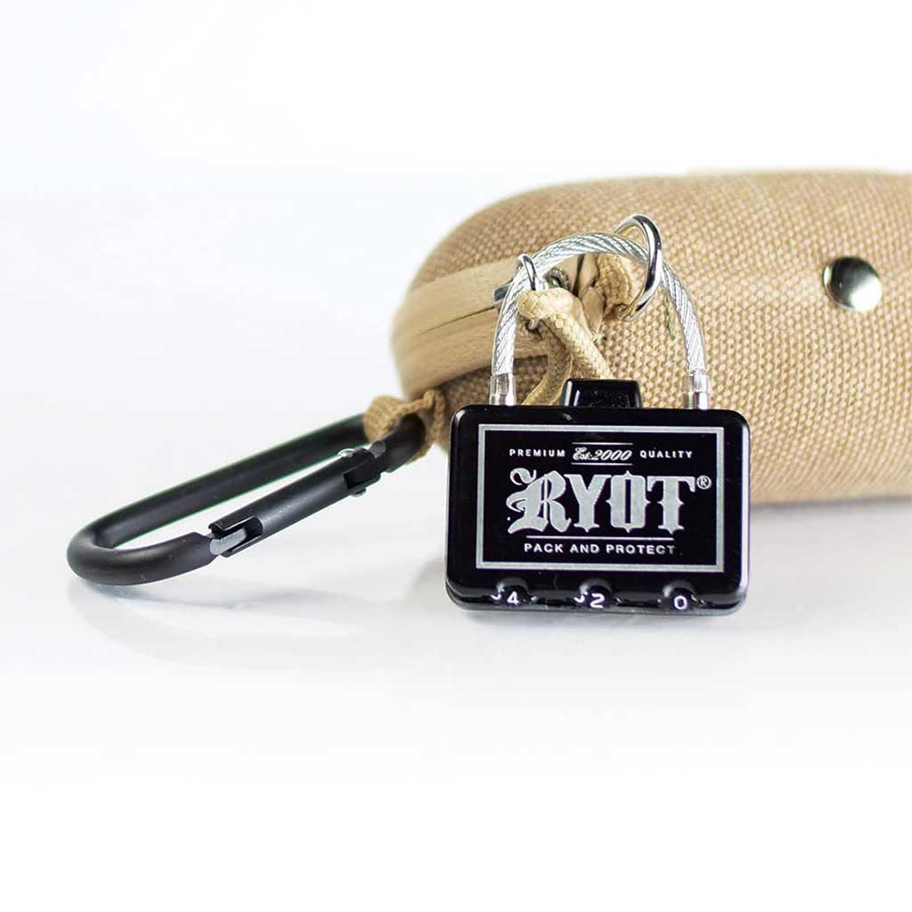 Close-up front view of a small black RYOT Hardcase lock attached to a tan fabric case with a black carabiner.