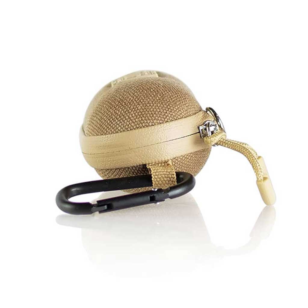 Angled close-up of a tan, spherical RYOT Hardcase with woven texture, leather trim, zipper pull, and attached black carabiner.