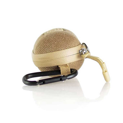 Angled close-up of a tan, spherical RYOT Hardcase with woven texture, leather trim, zipper pull, and attached black carabiner.