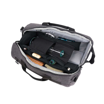 Top-down view of the open RYOT Pro-Duffle Carbon Series Smell-Proof Bag showing padded black interior compartments and several glass pieces neatly arranged.
