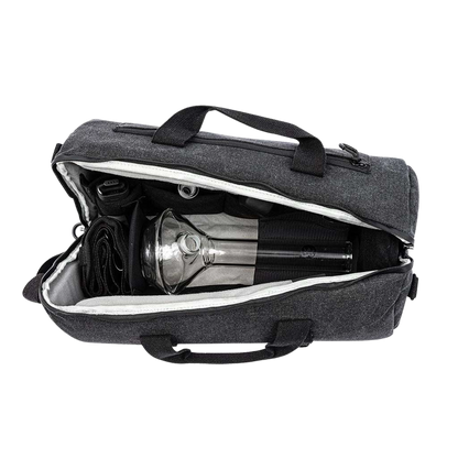 Top-down view of the open RYOT Pro-Duffle Carbon Series Smell-Proof Bag showing a gray fabric exterior, white inner lining, handles, and a glass piece secured inside.