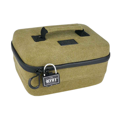 Angled close-up of an olive‑green RYOT Safe Case with a fabric top handle, black zipper trim, and a small branded padlock on the front.