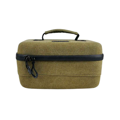 Front-facing view of an olive fabric RYOT Safe Case with a top handle and black zipper pulls against a white background