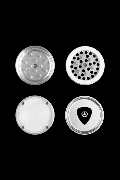 Four views of a silver cannabis grinder with patterned grinding surfaces.