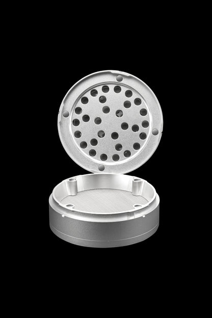 Silver cannabis grinder with open lid revealing a grated interior.