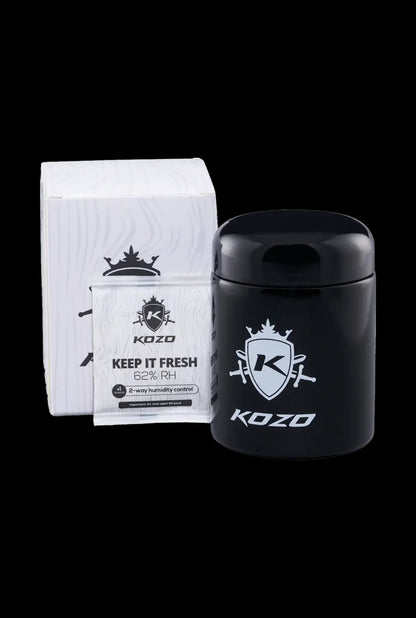 Front view of the Kozo Glass jars - 1/2 OZ with a black label and silver logo, angled slightly on a dark surface.