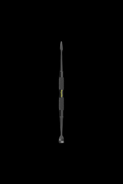 Black dab tool with textured grip, isolated on a black background.