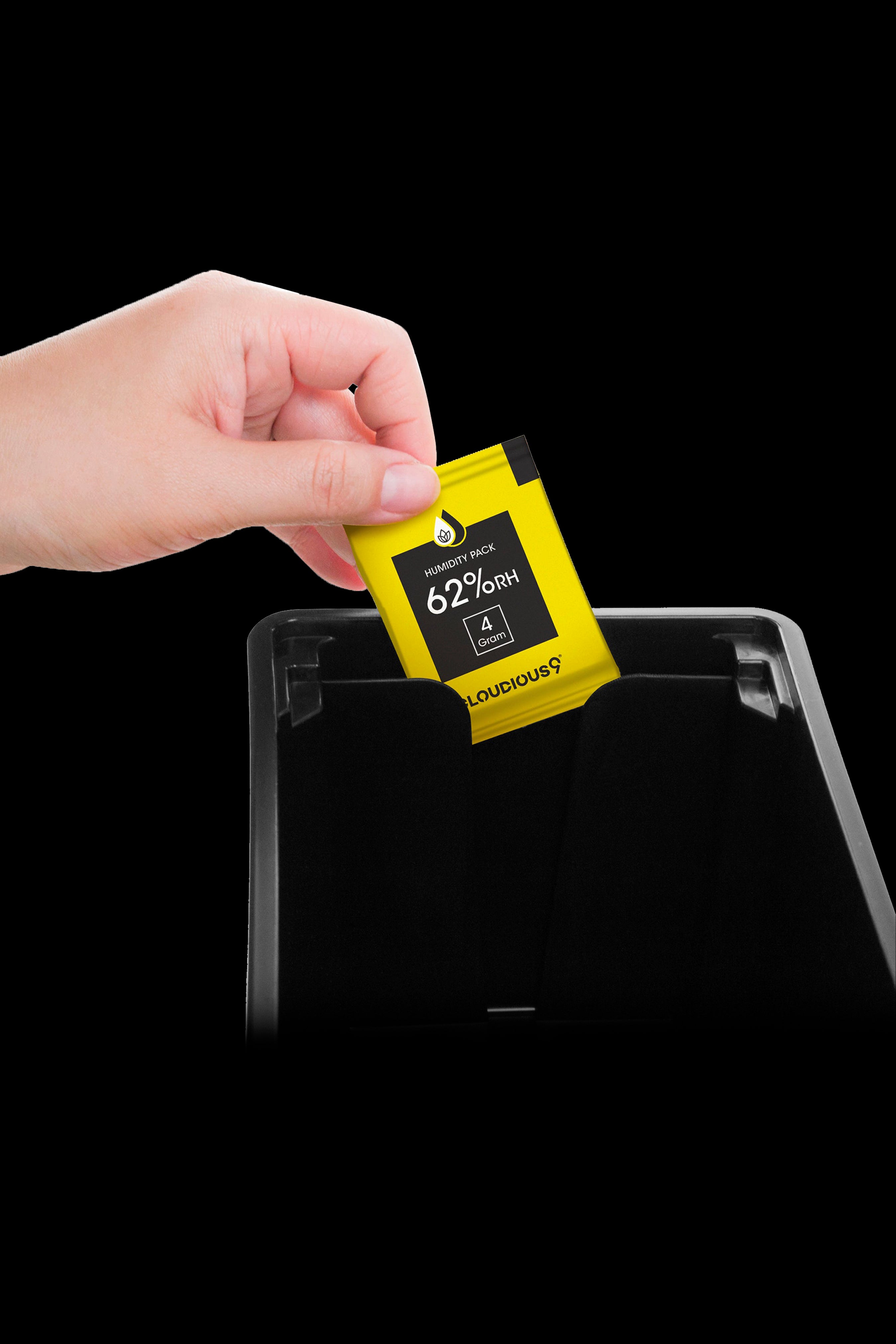 Hand placing a humidity pack into a storage container, likely for cannabis.