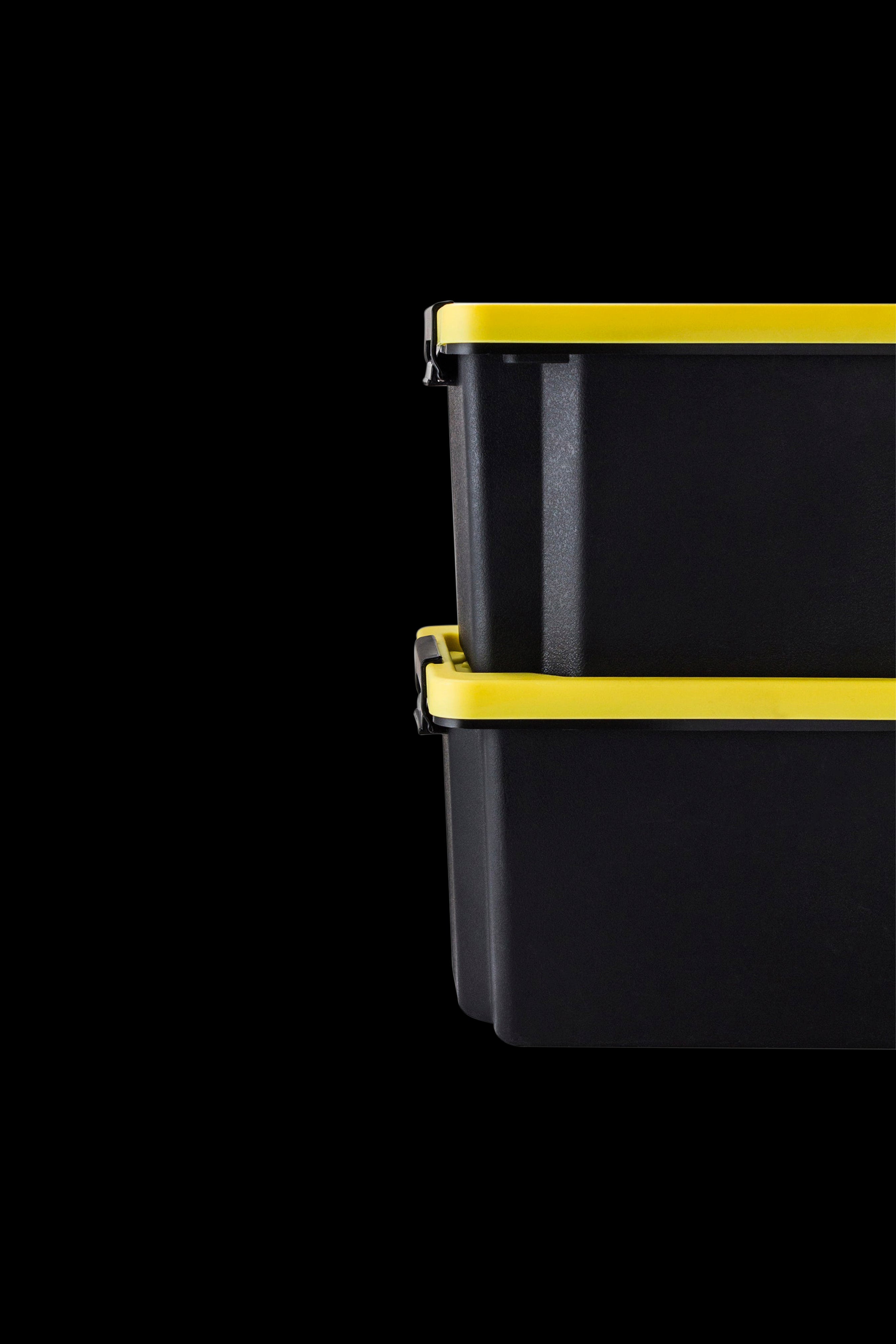 Black and yellow smell-proof container with latches, isolated on a black background.