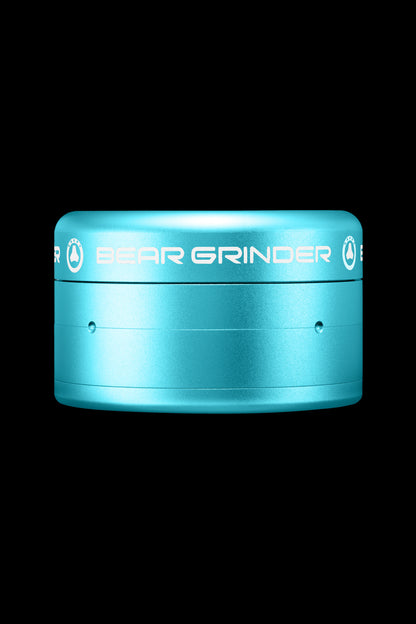 A teal metal cannabis grinder with “BEAR GRINDER” embossed on the side.