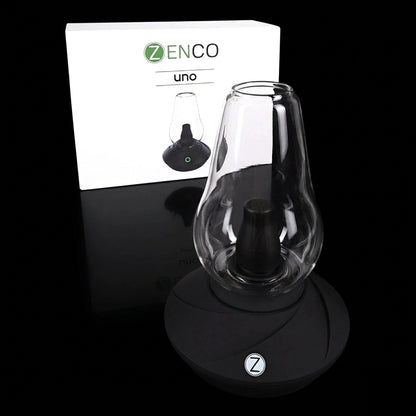 Close-up front view of the Zenco Uno Desktop Vaporizer on a glossy black surface with its white branded box in the background
