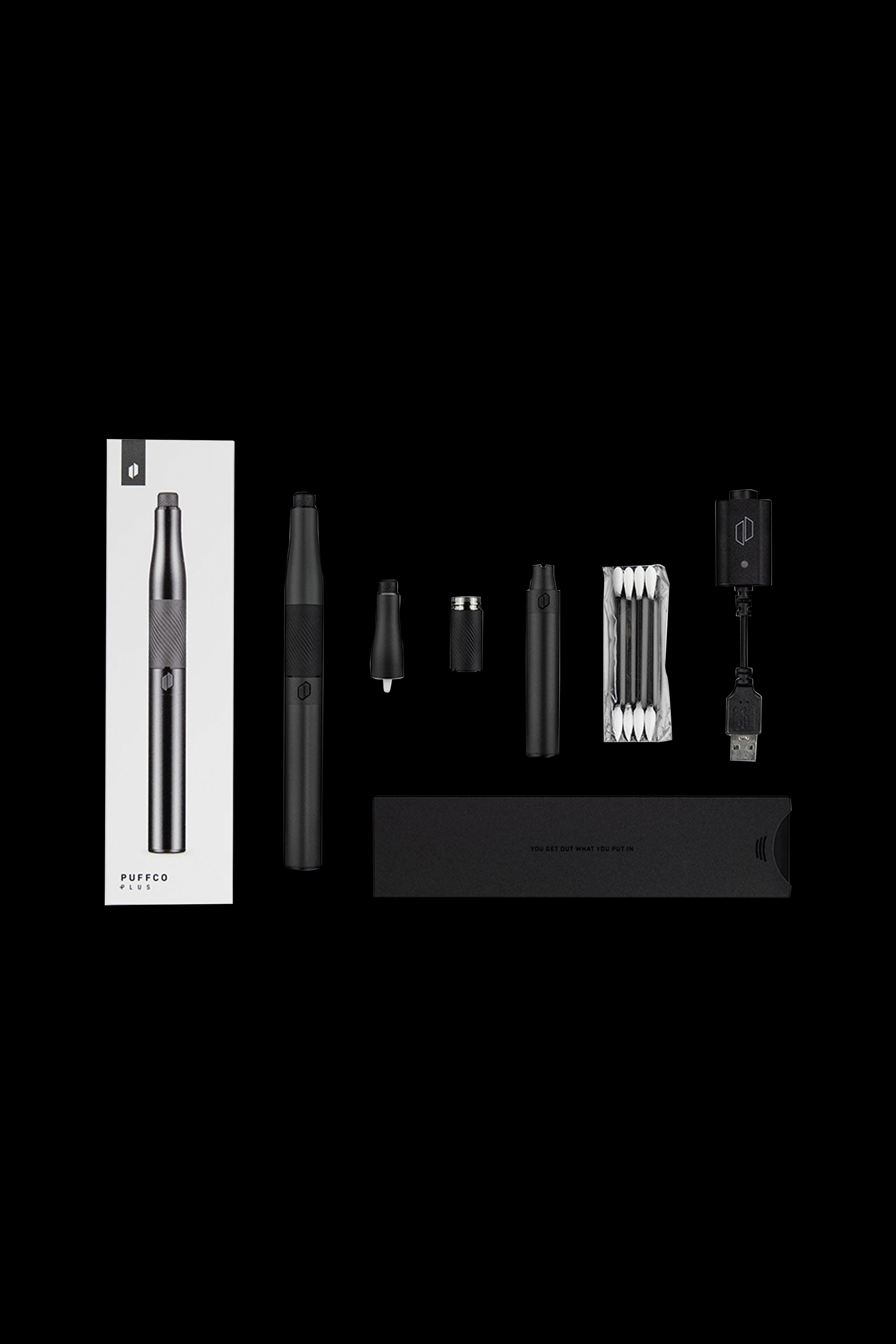 Puffco Plus vaporizing pen kit laid out with device, battery, atomizer, quartz crystal, USB charger, and packaging.