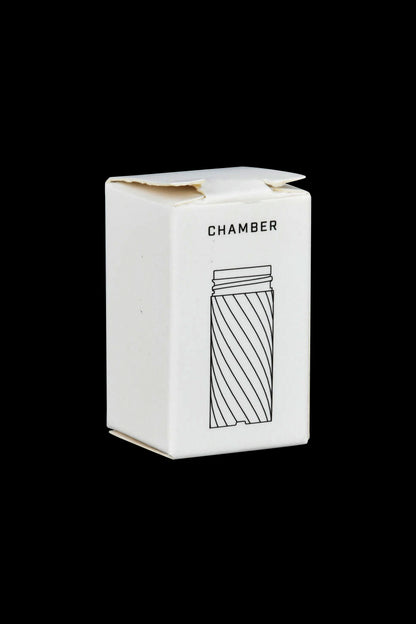 White packaging box for a cannabis accessory, featuring a line drawing of a cylindrical smoking device labeled "CHAMBER."