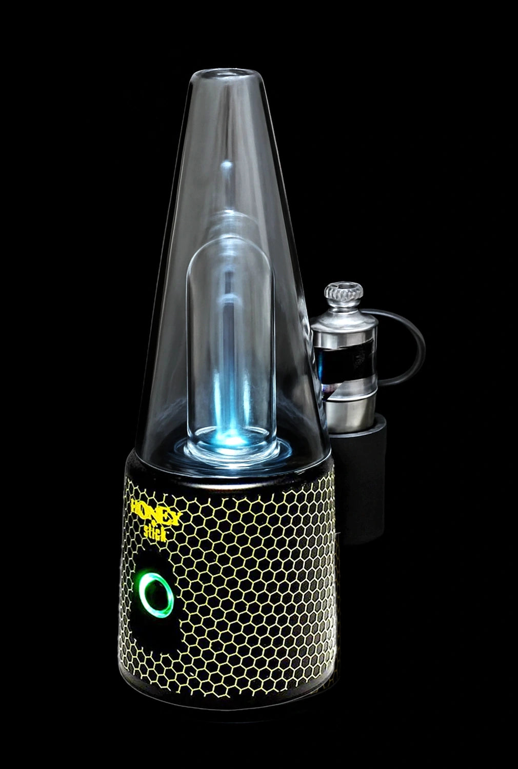 A lit, portable dab rig with a honeycomb-textured base and glowing blue interior, accompanied by a metal carb cap.