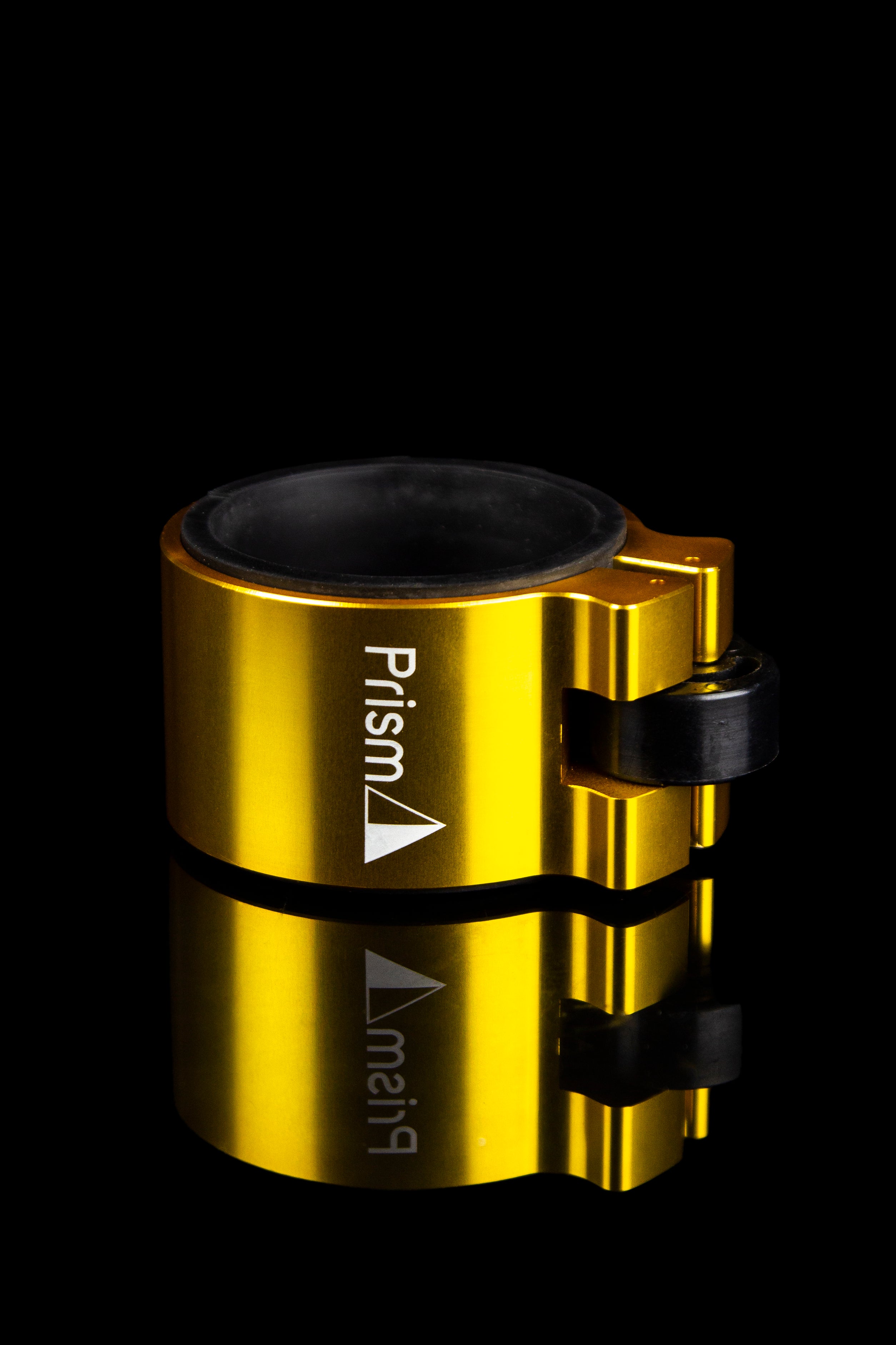 Gold cannabis vaporizer with "Prism" branding and reflective surface.