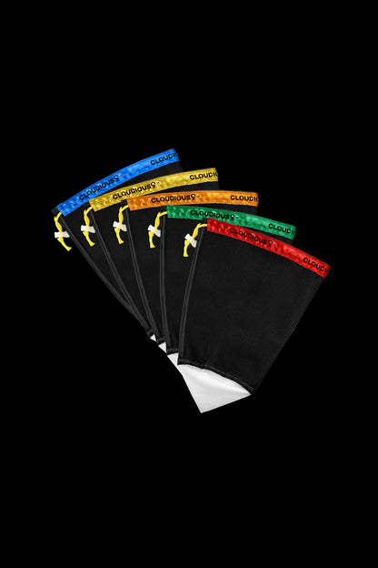 A stack of black cannabis smoking filters with colorful branding.