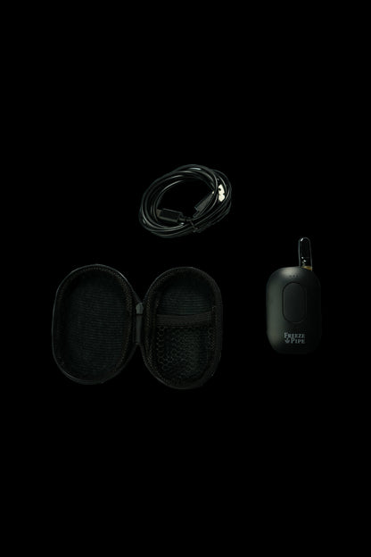 Black Freeze Pipe electronic dab rig with carrying case and USB charging cable on a dark background.