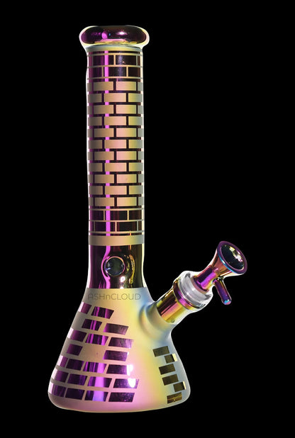 Front three-quarter view of the Smoke Cartel Electro Plated Beaker Bong - 10 in. showing its iridescent purple-gold finish and brick-patterned neck against a black background