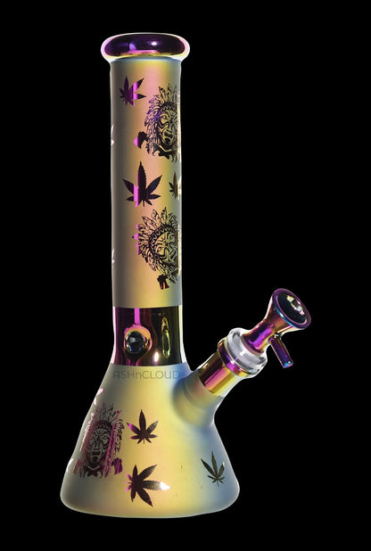 Angled front view of the Smoke Cartel Electro Plated Beaker Bong - 10 in., showing its iridescent purple-gold finish and leaf motifs.