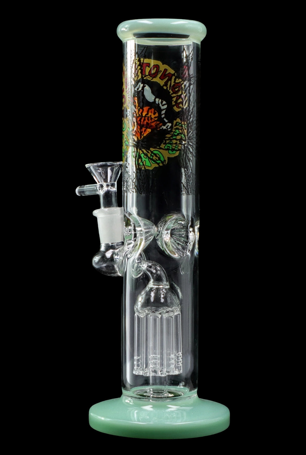 A glass bong with a green base and colorful, illustrative artwork depicting skulls and floral designs.