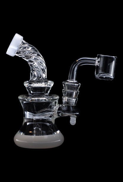 Clear glass dab rig with intricate percolators and a quartz nail, isolated on a black background.