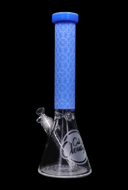 Blue glass bong with intricate geometric patterns and a clear glass downstem, isolated on a black background.