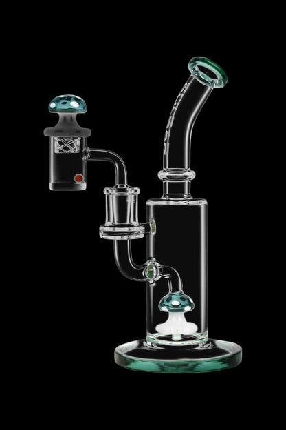 Clear glass water pipe (rig) with mushroom-shaped attachments, isolated on a black background.