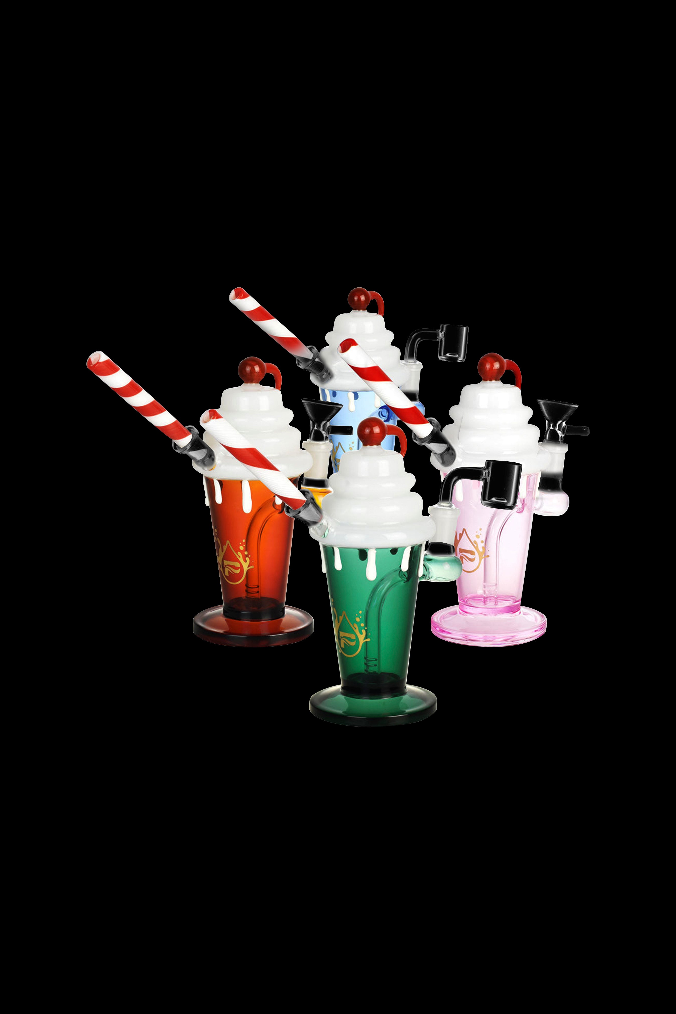 Glass cannabis water pipes shaped like colorful ice cream sundaes with striped straws and cherry toppers on a black background.
