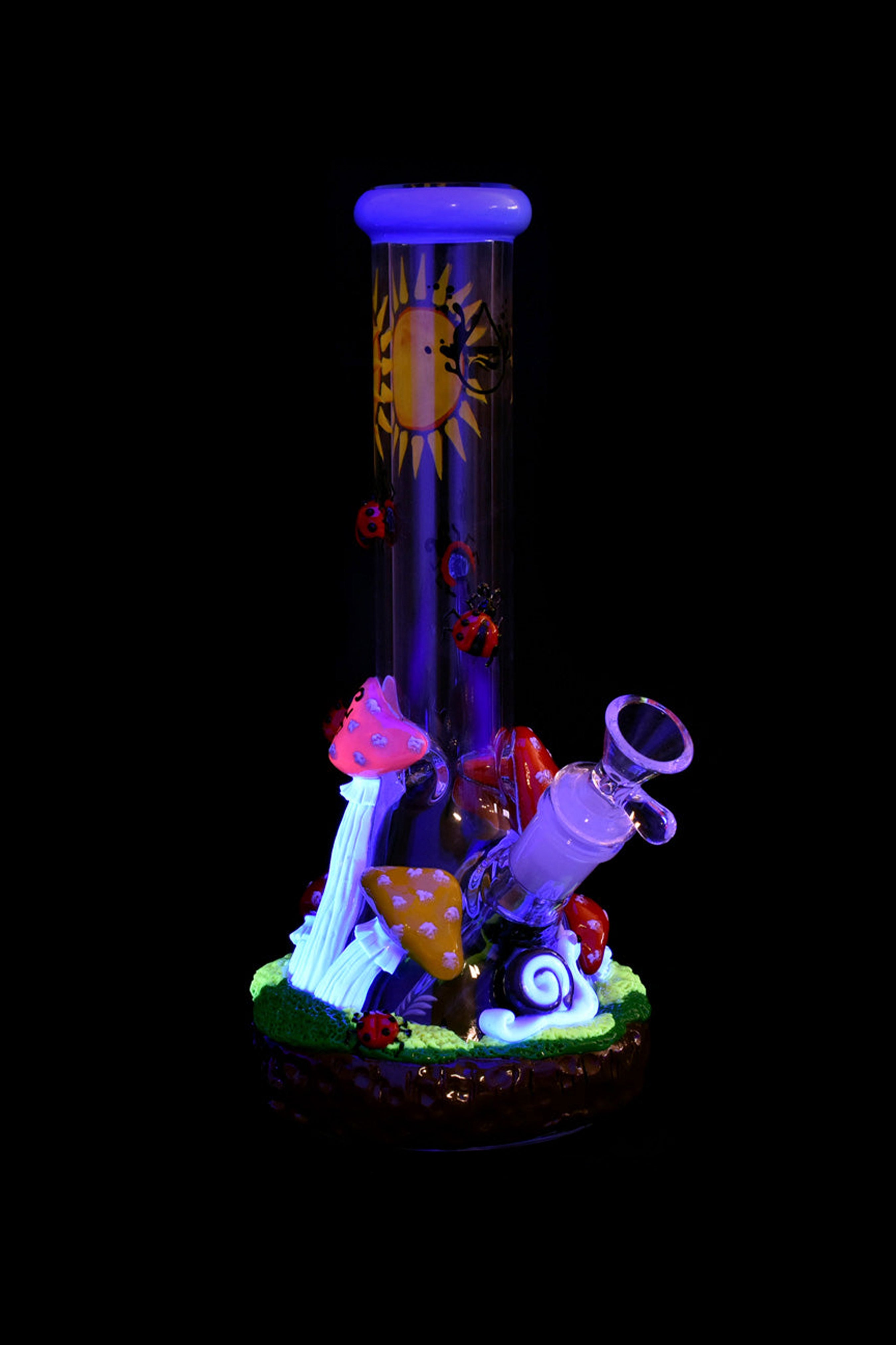 Glow-in-the-dark glass water pipe decorated with sculpted mushrooms and psychedelic details, isolated on black.