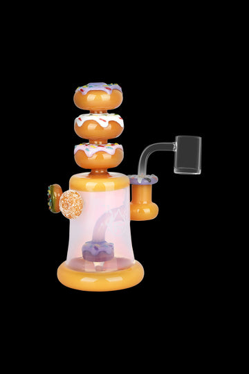 Hand-blown glass dab rig shaped like a stack of colorful donuts, with a clear water chamber and attached quartz nail. - Pulsar Dreamy Donuts Dab Rig