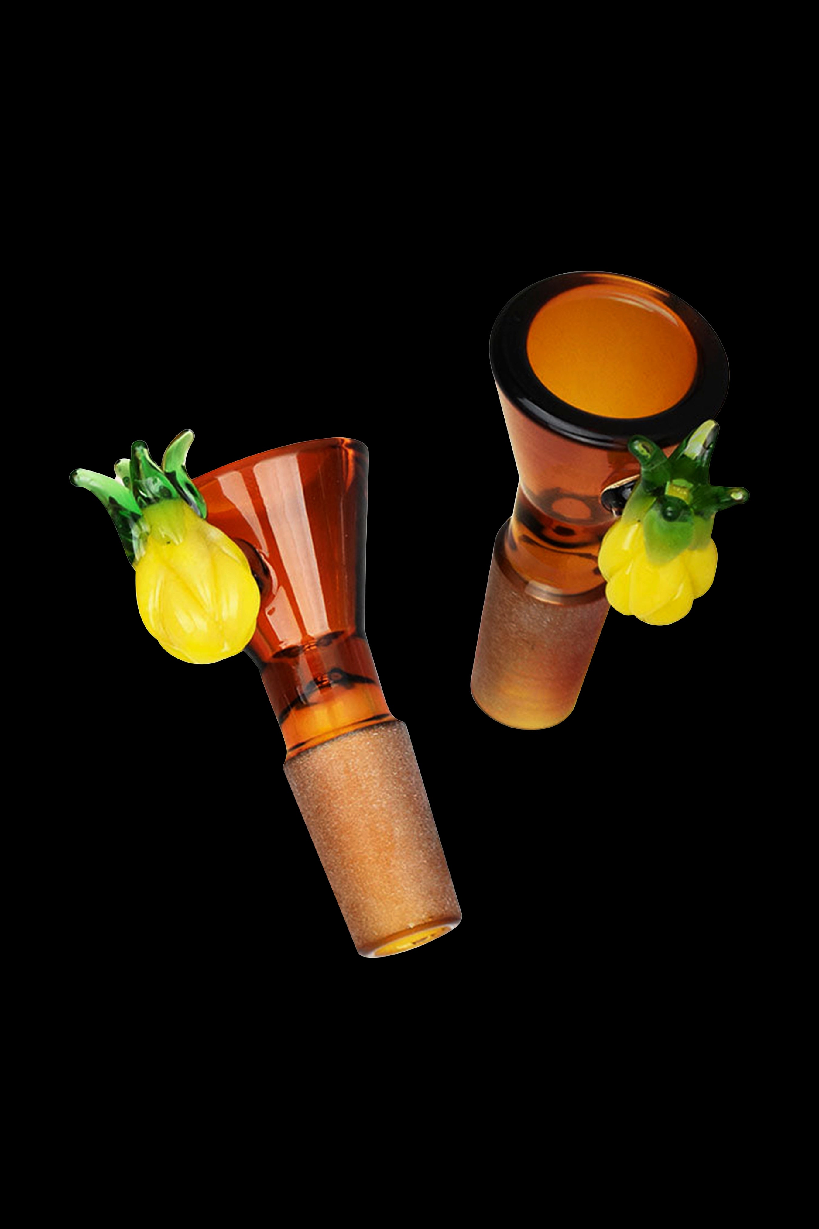 Amber glass cannabis bowls with sculpted pineapple accents against a black background.