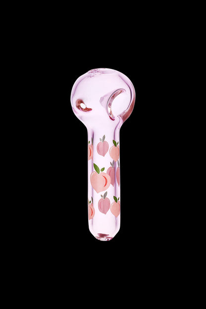 Pink glass pipe with peach pattern against a black background.