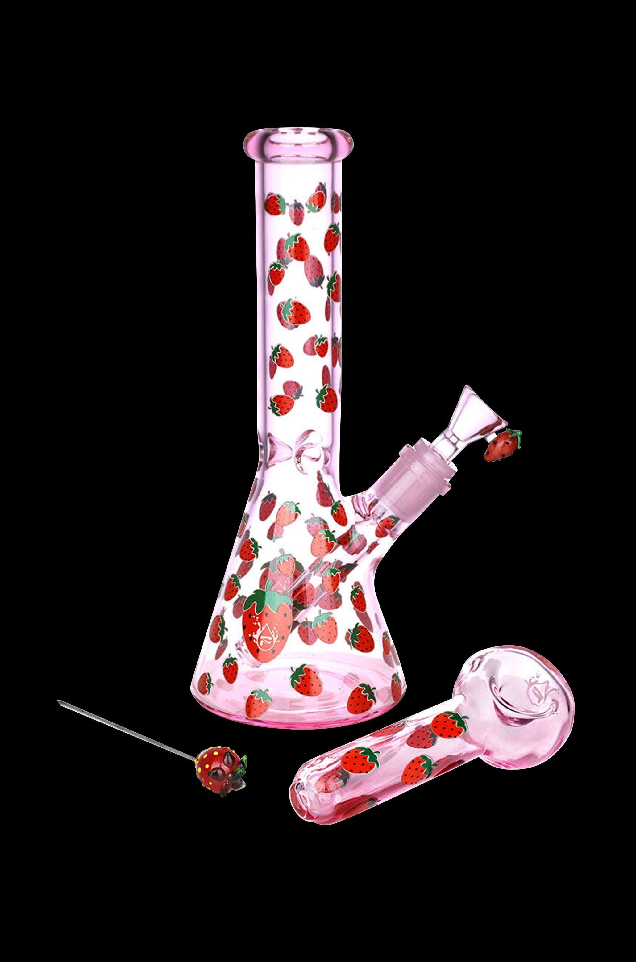 Pink glass water pipe and bowl decorated with strawberries, with a strawberry-shaped tool.