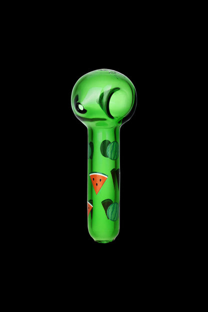 Green glass pipe decorated with watermelon slices against a black background.