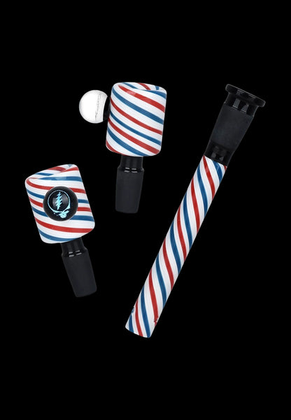 Cannabis accessories featuring a red, white, and blue striped design, including a bubbler, attachment, and cap, against a black background.