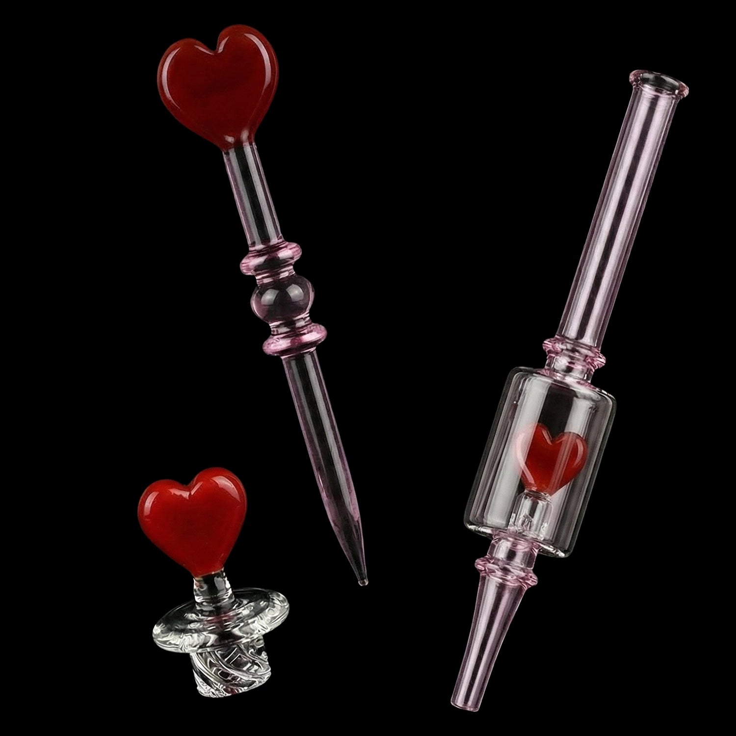 Angled close-up of the Pulsar Valentine's Love Hearts Glass Dab Rig Set - 8.5" / 14mm F showing pink glass stems and red heart accents against a black background