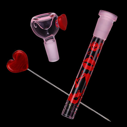 Angled close-up of the Pulsar Valentine's XOXO Glass Beaker Water Pipe & Hand Pipe Set - 10" showing pink joint pieces and red heart accents.