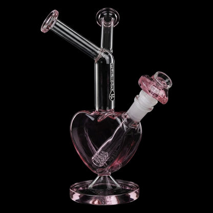Angled close-up of the Pulsar Double Kiss Heart Glass Water Pipe - 11" / 14mm F showing its pink-tinted heart chamber, tilted necks, and black background