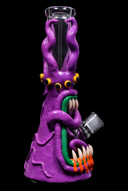 Purple glass octopus-shaped water pipe with orange claws and green accents, isolated on black.